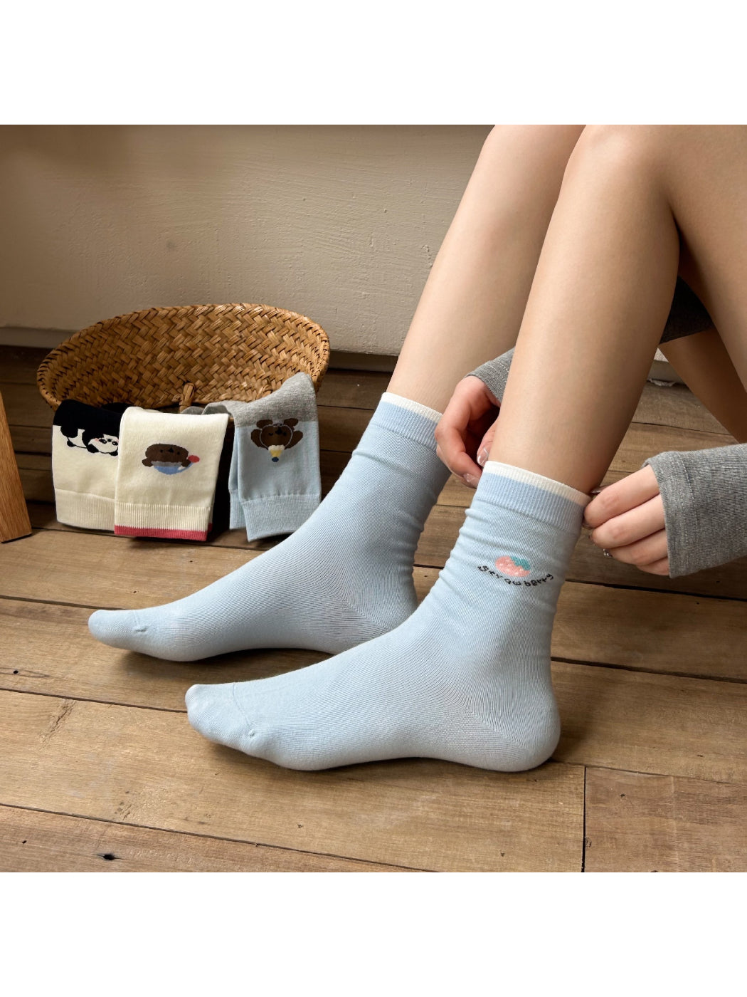 Rufia soft crew socks featuring a smiling bear face and paw prints on cream fabric