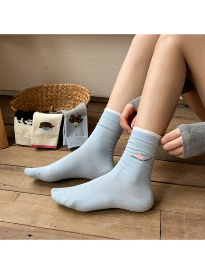 Rufia soft crew socks featuring a smiling bear face and paw prints on cream fabric