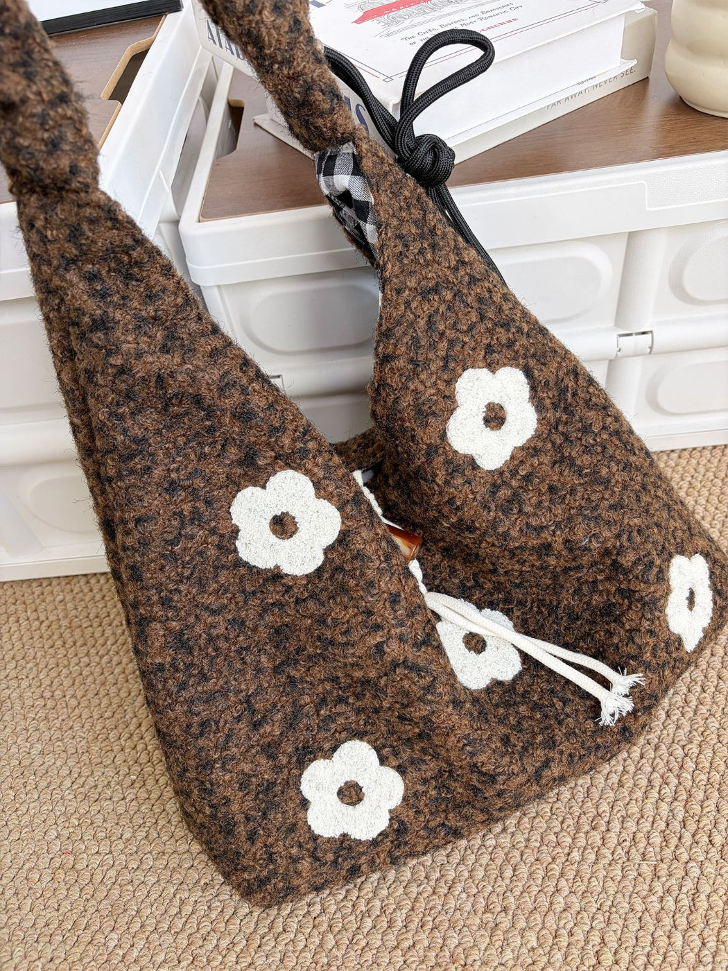 Cosbai floral knit drawstring shoulder bag folded to show flexibility and fabric
