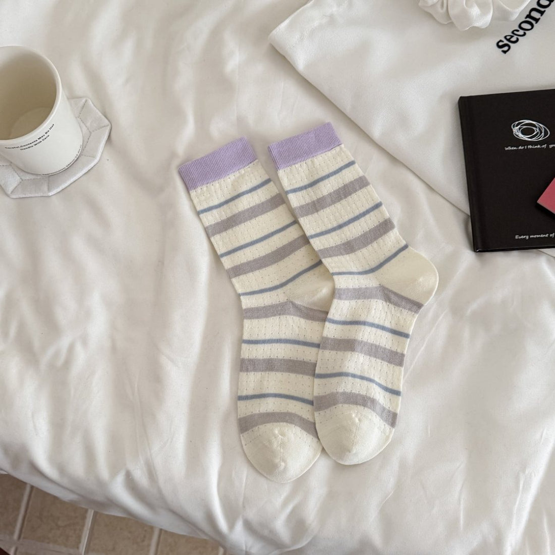 Pair of Rufia soft flecked knit crew socks with subtle fleck pattern in natural light
