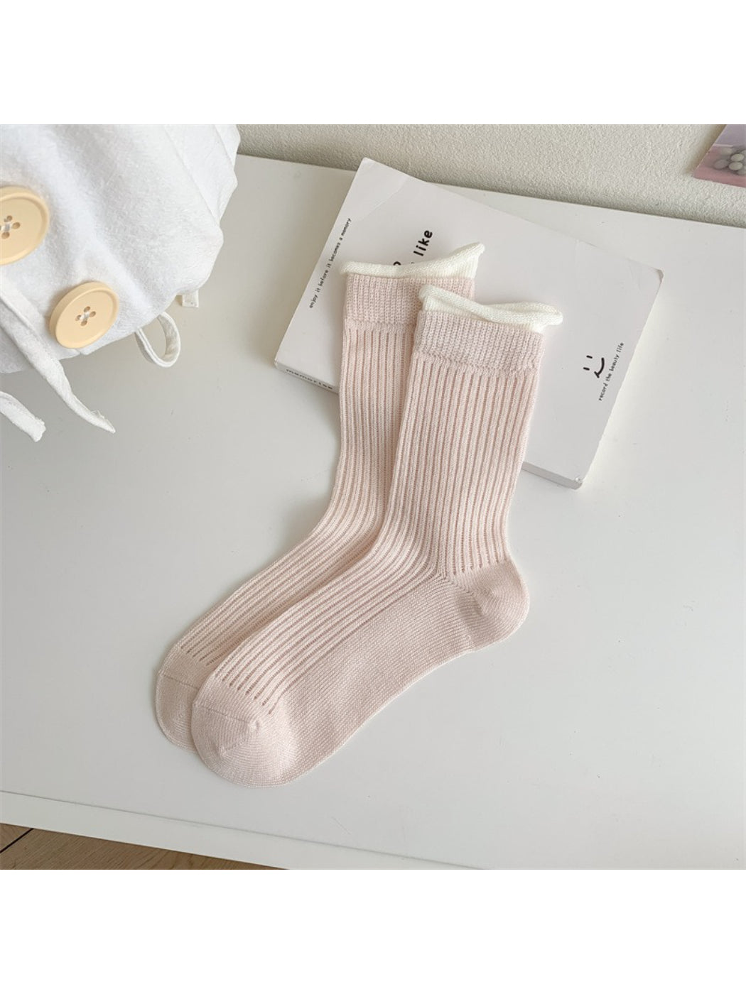 Rufia ribbed crew socks with multicolor pastel contrast trim arranged in a fan shape