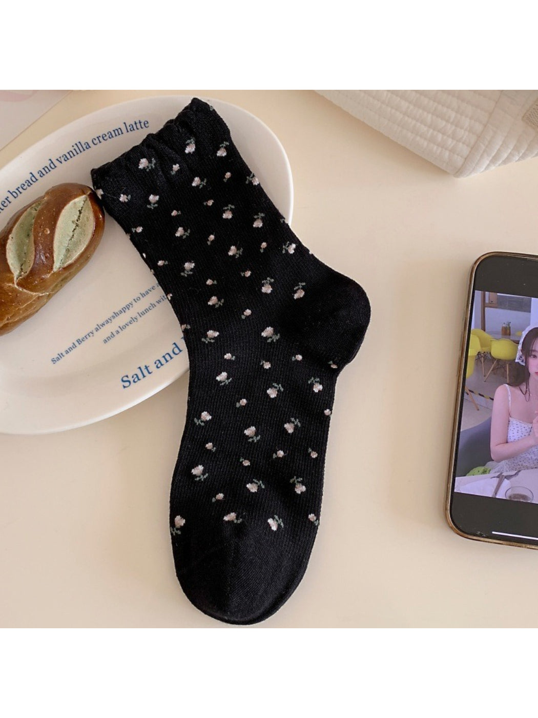 Rufia Tiny Blossom socks worn on feet showing fit and floral pattern with frill trim