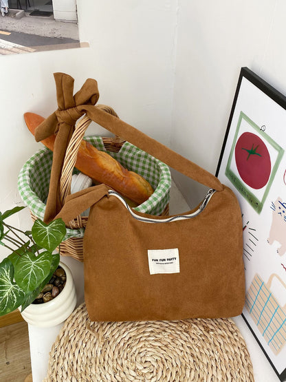 Side view of Cosbai slouchy shoulder bag highlighting its relaxed shape