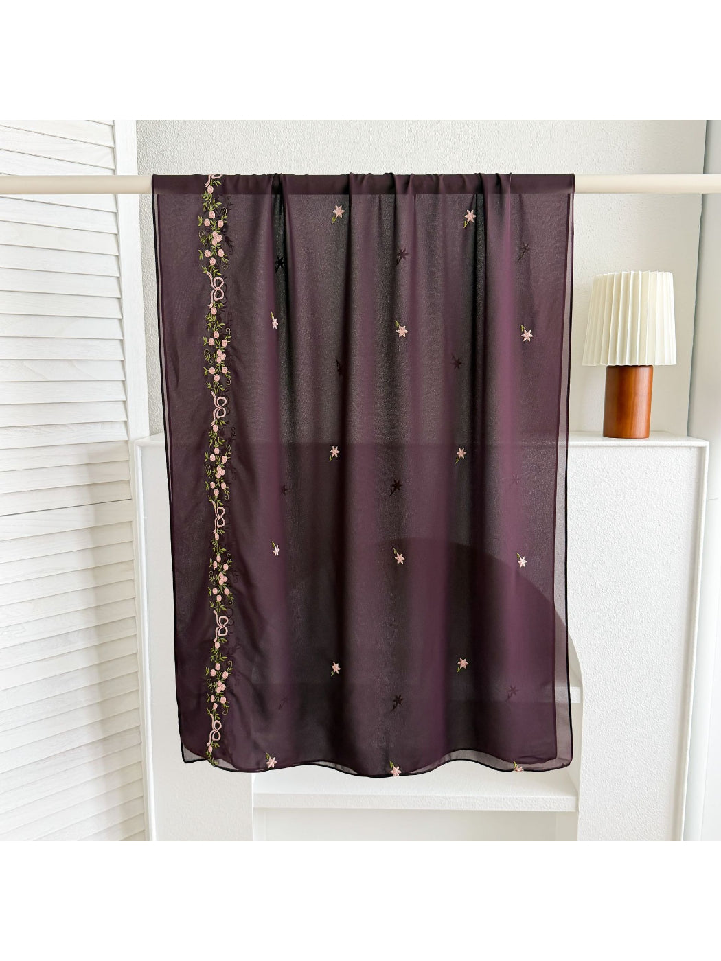 Close-up of scarf edge with delicate embroidery and soft fabric