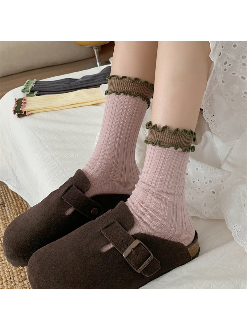 Pair of Rufia ruffle color block crew socks worn on feet showing color block pattern