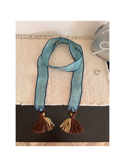 Scarvii boho skinny scarf wrapped loosely around neck with tassels visible