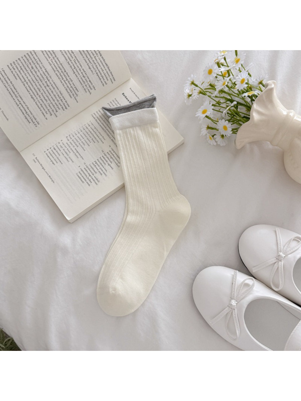 Rufia ribbed socks worn by model standing on wooden floor