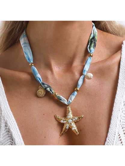 Ocean Charm beaded necklace with blue and white beads on a white background