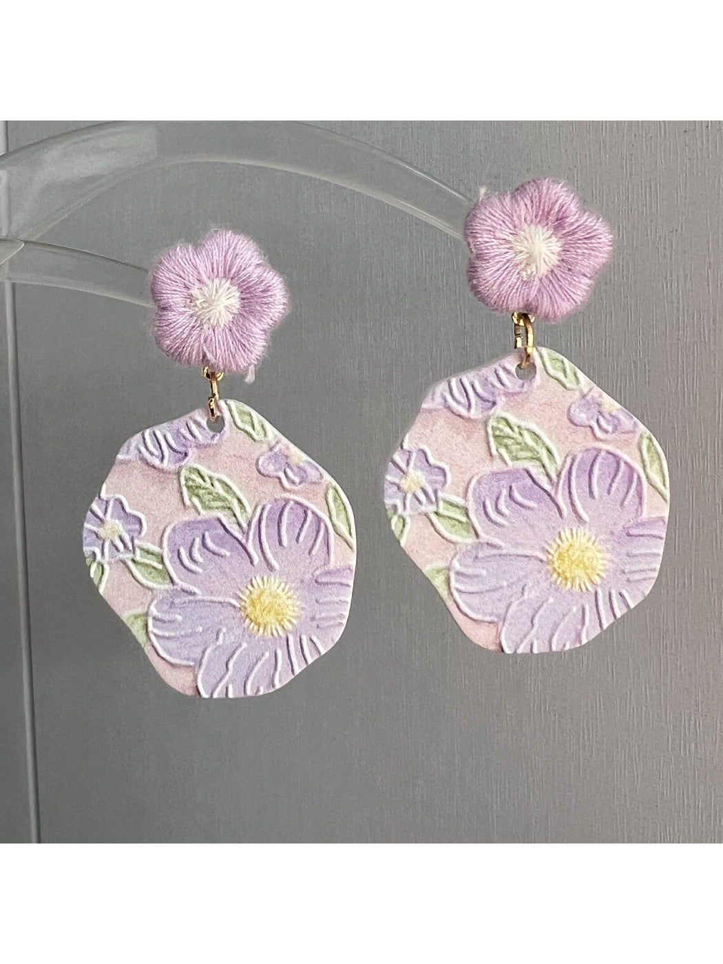 Close-up of Earwish Purple Bloom Drop Earrings with purple flower design and silver hooks