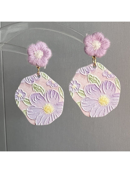 Close-up of Earwish Purple Bloom Drop Earrings with purple flower design and silver hooks