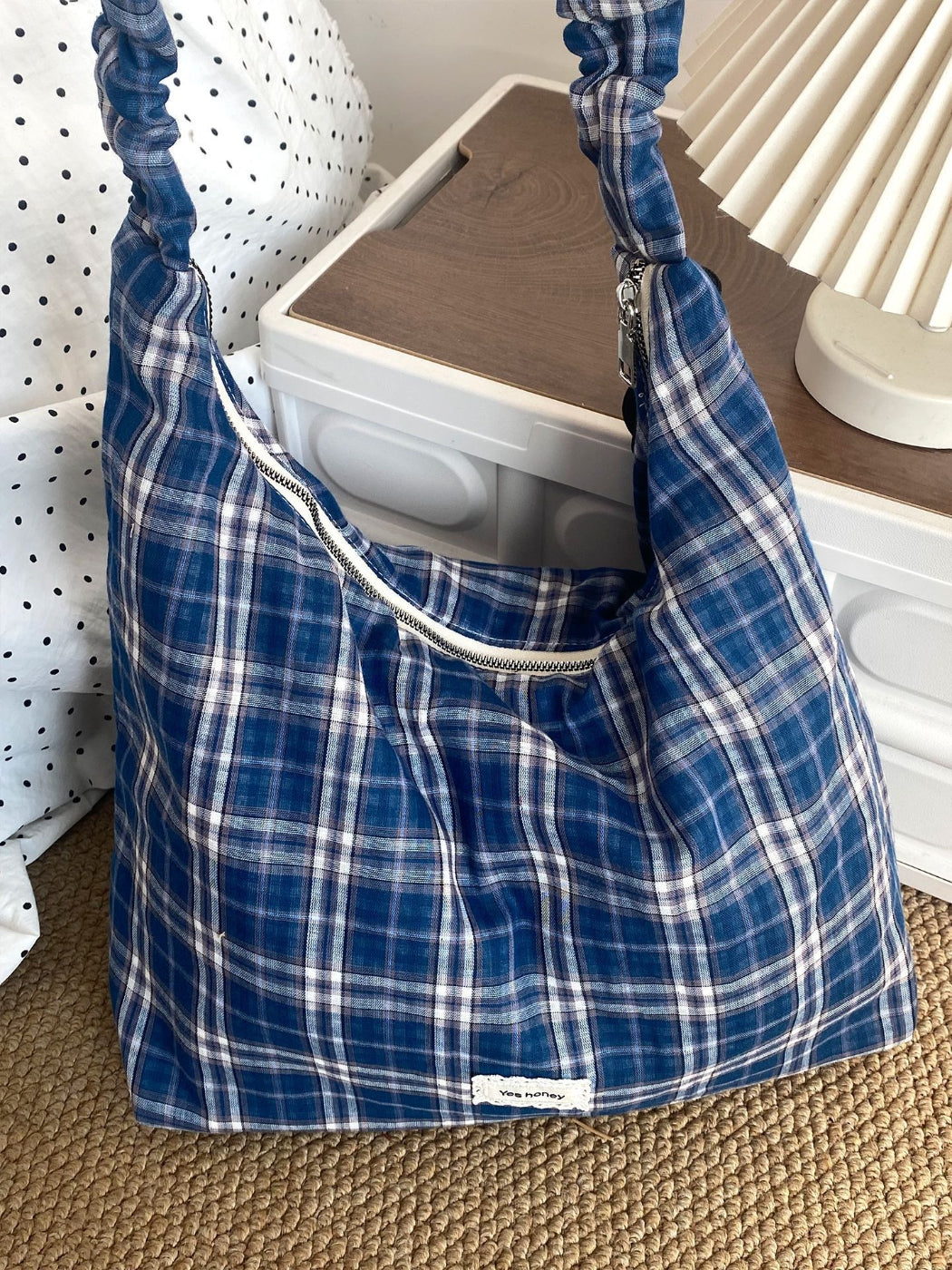 Cosbai plaid slouchy shoulder bag displayed on wooden surface with soft lighting