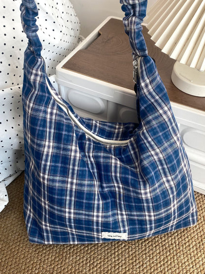 Cosbai plaid slouchy shoulder bag displayed on wooden surface with soft lighting