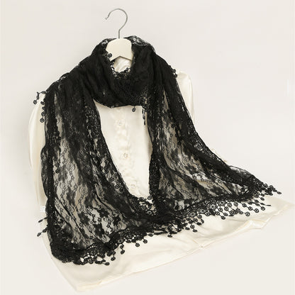 Close-up of delicate floral lace pattern on sheer wrap scarf