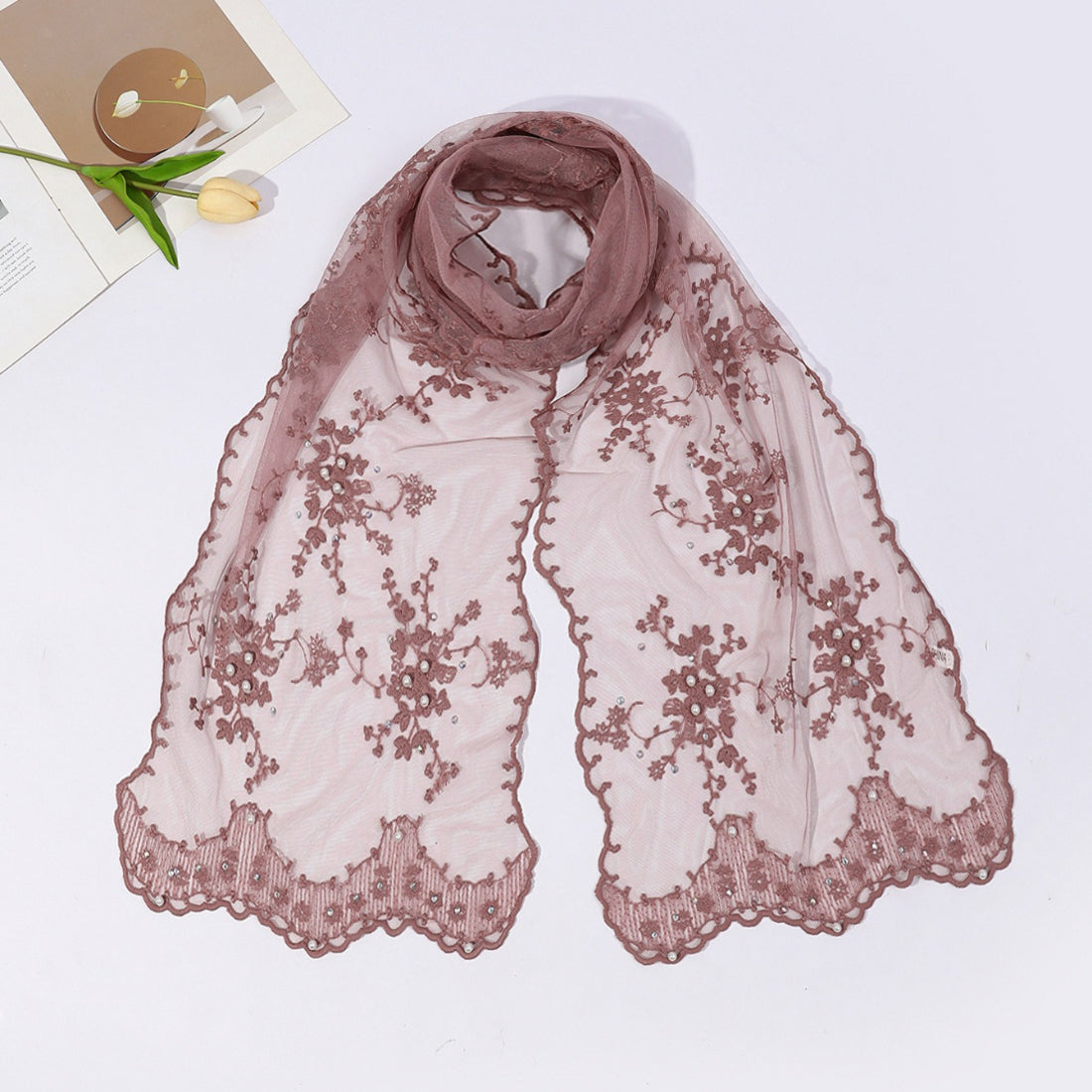 Close-up of botanical mesh scarf fabric texture highlighting sheer material