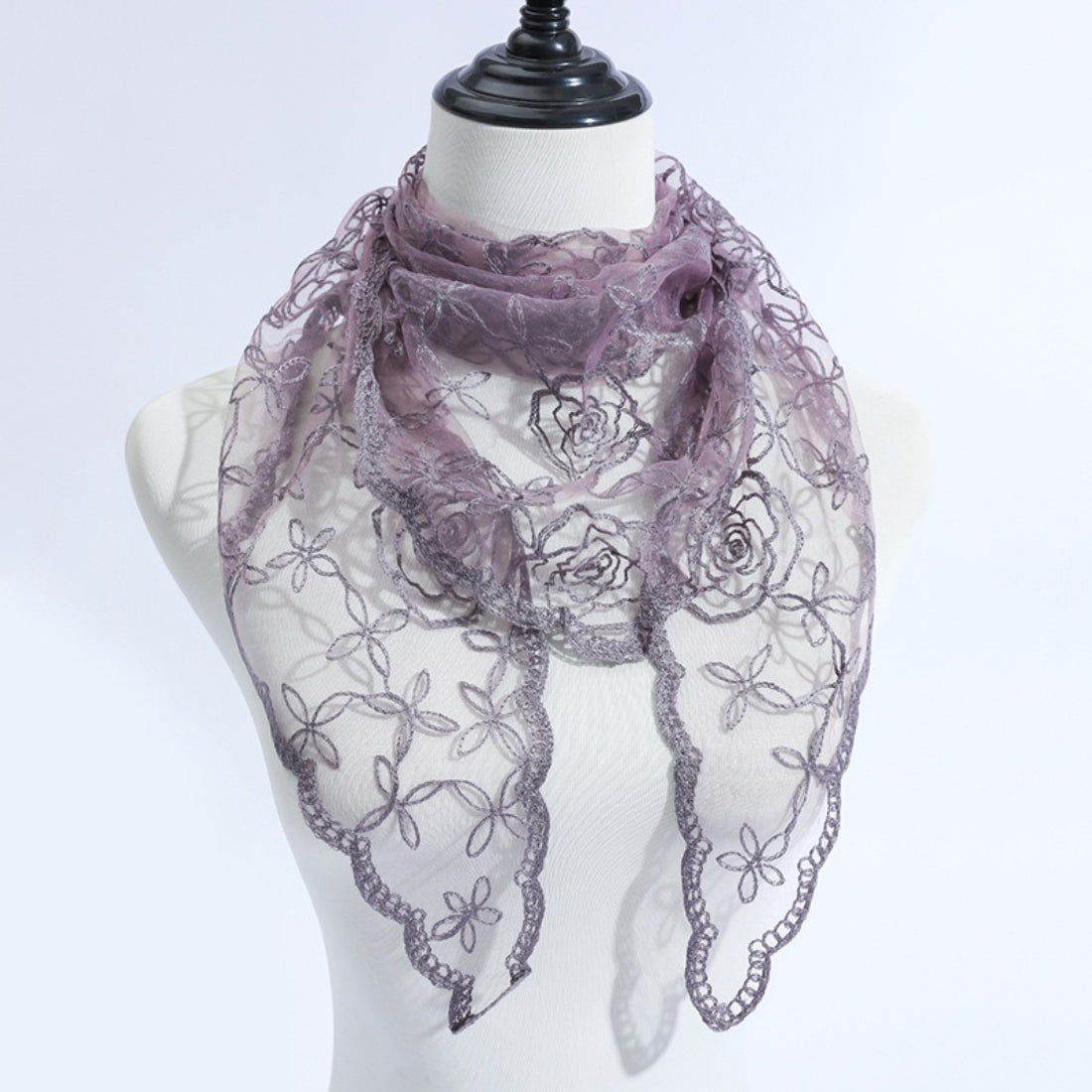 Model adjusting Haila veil scarf with rose vine lace in natural light