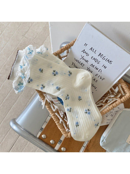 Rufia socks laid flat highlighting the combination of flowers and stripes