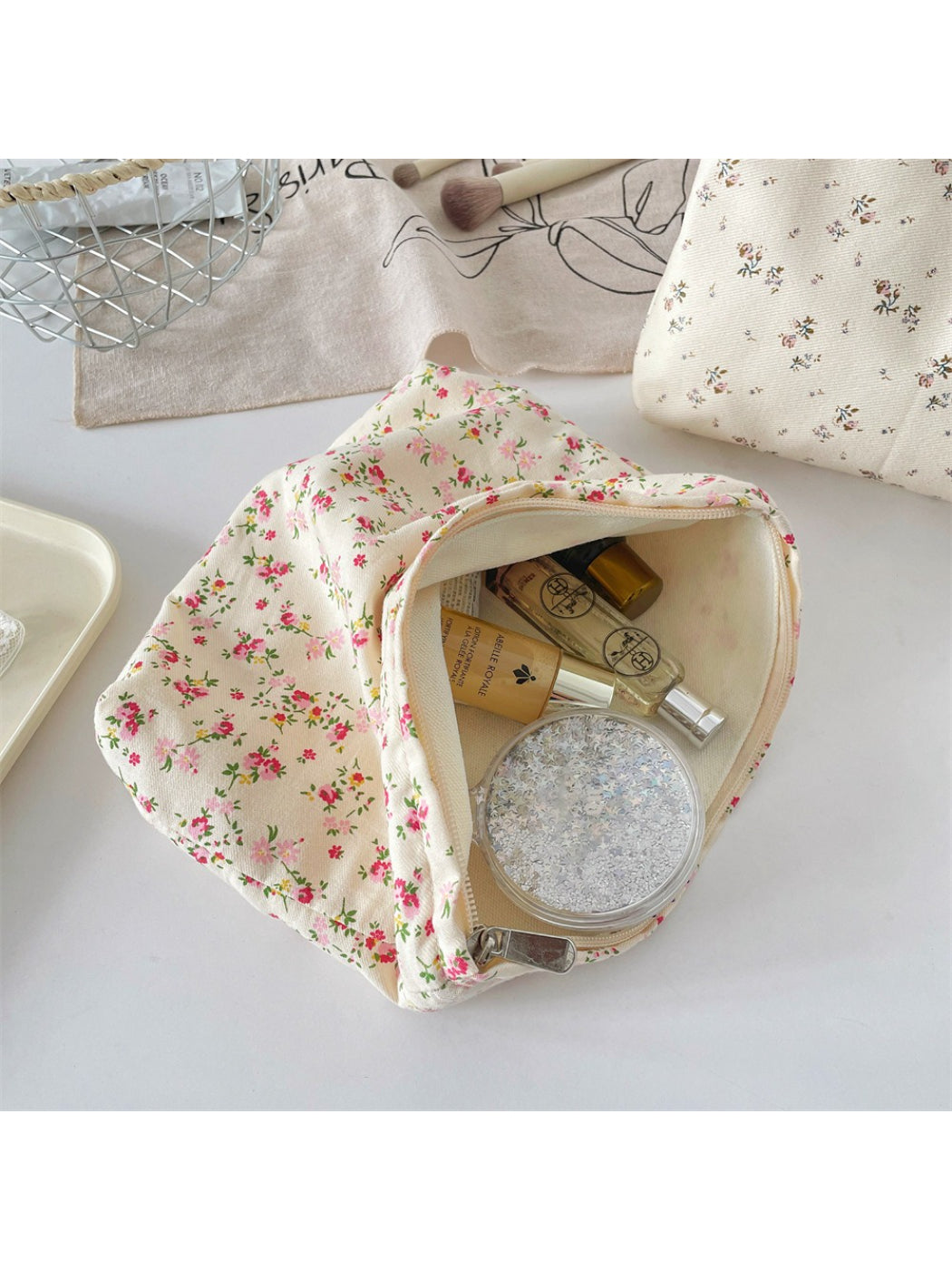 Cosbai cosmetic pouch displayed with matching floral accessories on white background