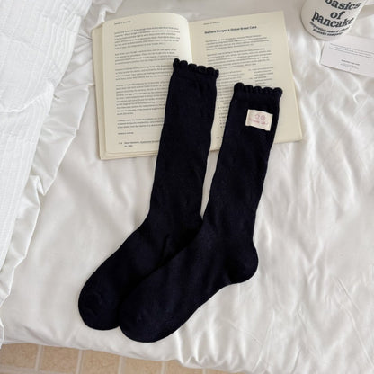 Side view of Rufia Fine Stripe Charm Crew Socks displaying the stripe detail and heel