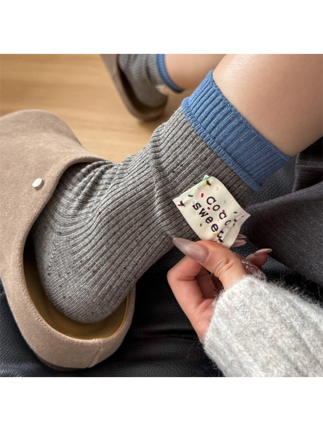 Close-up of Rufia speckle knit texture on beige crew sock