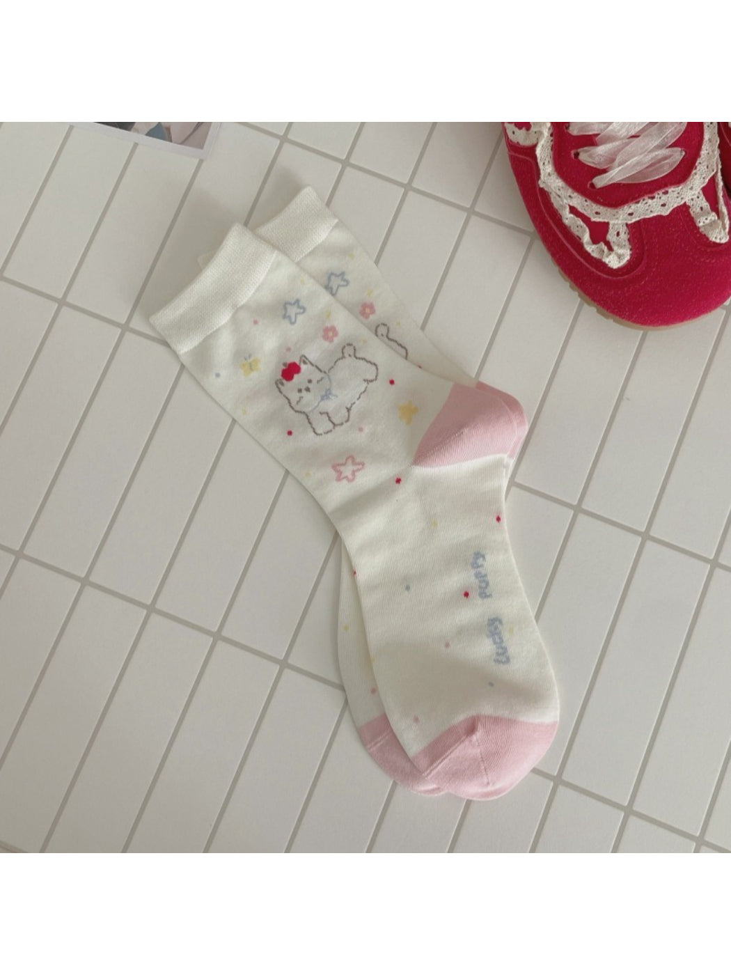 Rufia dog mid-calf socks displayed with one sock rolled down to show length
