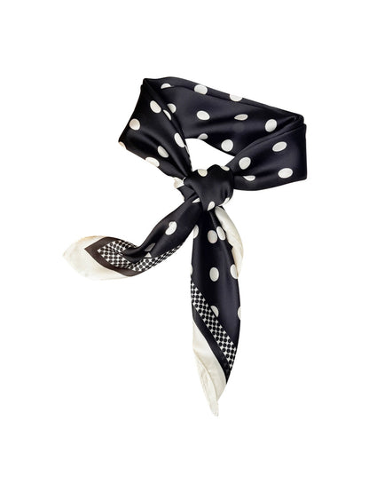 Model wearing Scarvii contrast polka dot scarf styled around the neck
