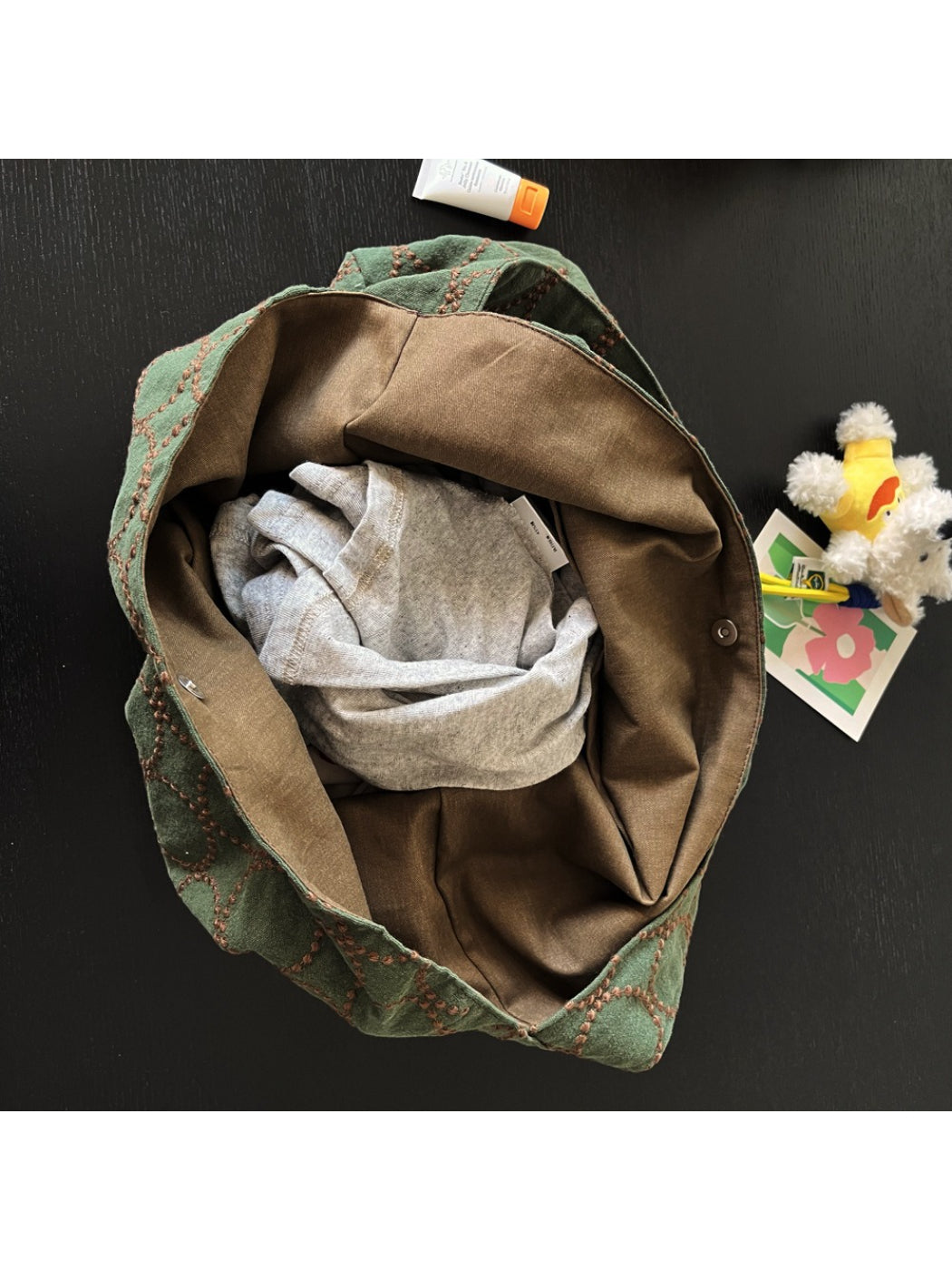 Cosbai tote bag worn on shoulder demonstrating size and fit with dog charm visible