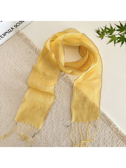 Model with sheer solid summer scarf tied in a casual knot over a white top