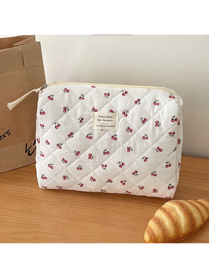 Open view of soft quilted cherry storage pouch showing interior space