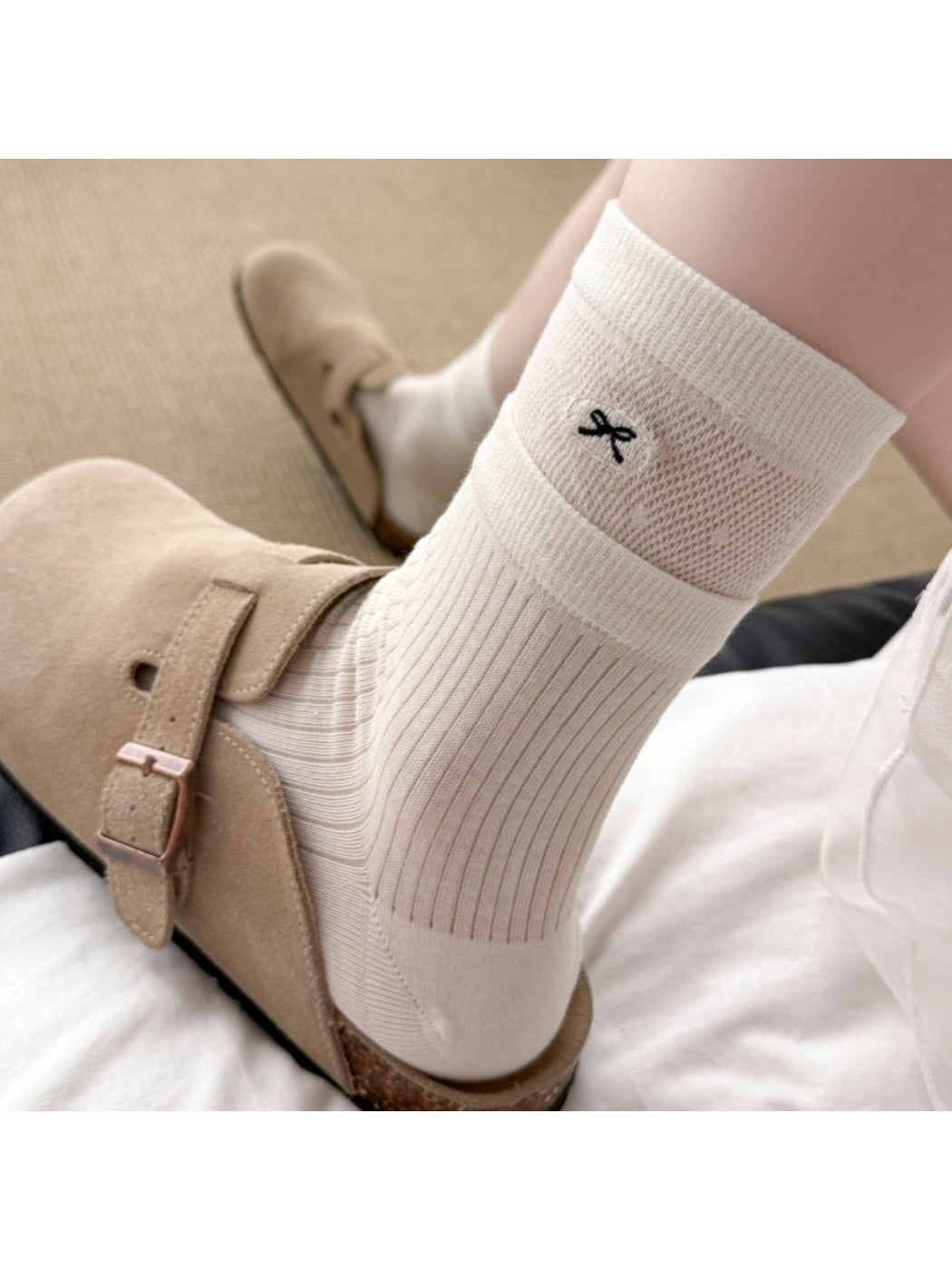 Rufia embroidered mesh mid-calf socks worn on feet with visible embroidery pattern