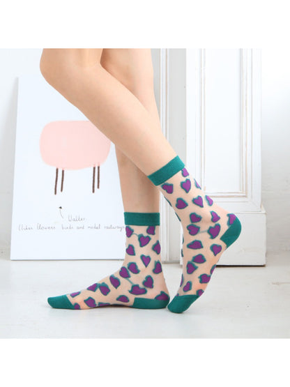 Model wearing Rufia Candy Heart sheer crew socks with white shoes