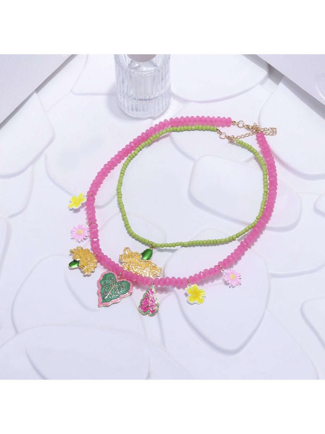 Model wearing Neckit Summer Fruit Necklace with visible fruit and floral charm details