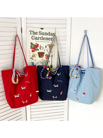 Side view of Cosbai everyday tote bag showing beige handles and puppy print