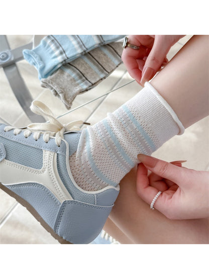 Pair of Rufia rolled edge stripe socks in navy and white stripes laid flat