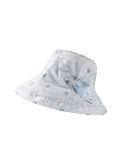 Model wearing Haila polka dot bow brim hat outdoors in natural light