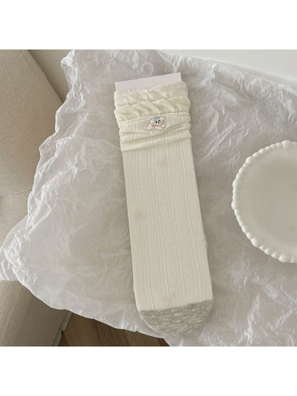 Side view of Rufia crew socks highlighting the animal motifs and ankle length