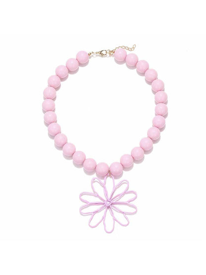 Model wearing Neckit Statement Flower Pendant Beaded Necklace with flower pendant centered