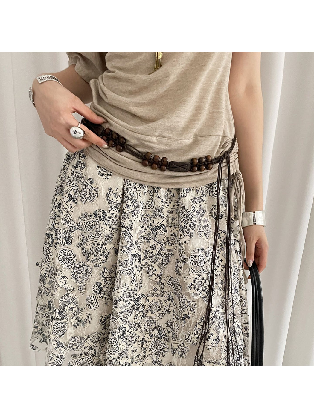 Close-up of Beco brown beaded tie waist belt with wooden beads and fabric ties