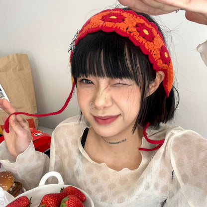 Model wearing Haila crochet flower hairband outdoors in summer setting