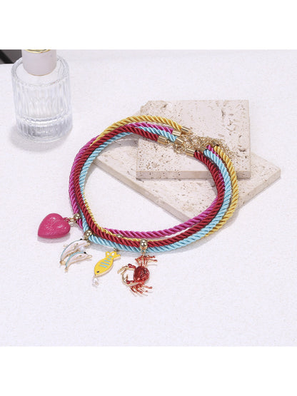 Colorful rope necklace with ocean charms worn on a mannequin bust