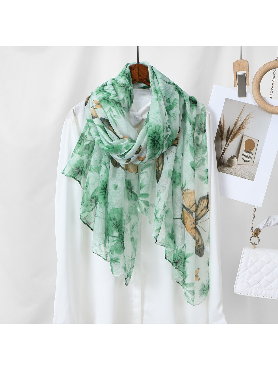 Model wearing Scarvii botanical butterfly print scarf around the neck