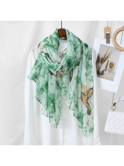 Model wearing Scarvii botanical butterfly print scarf around the neck