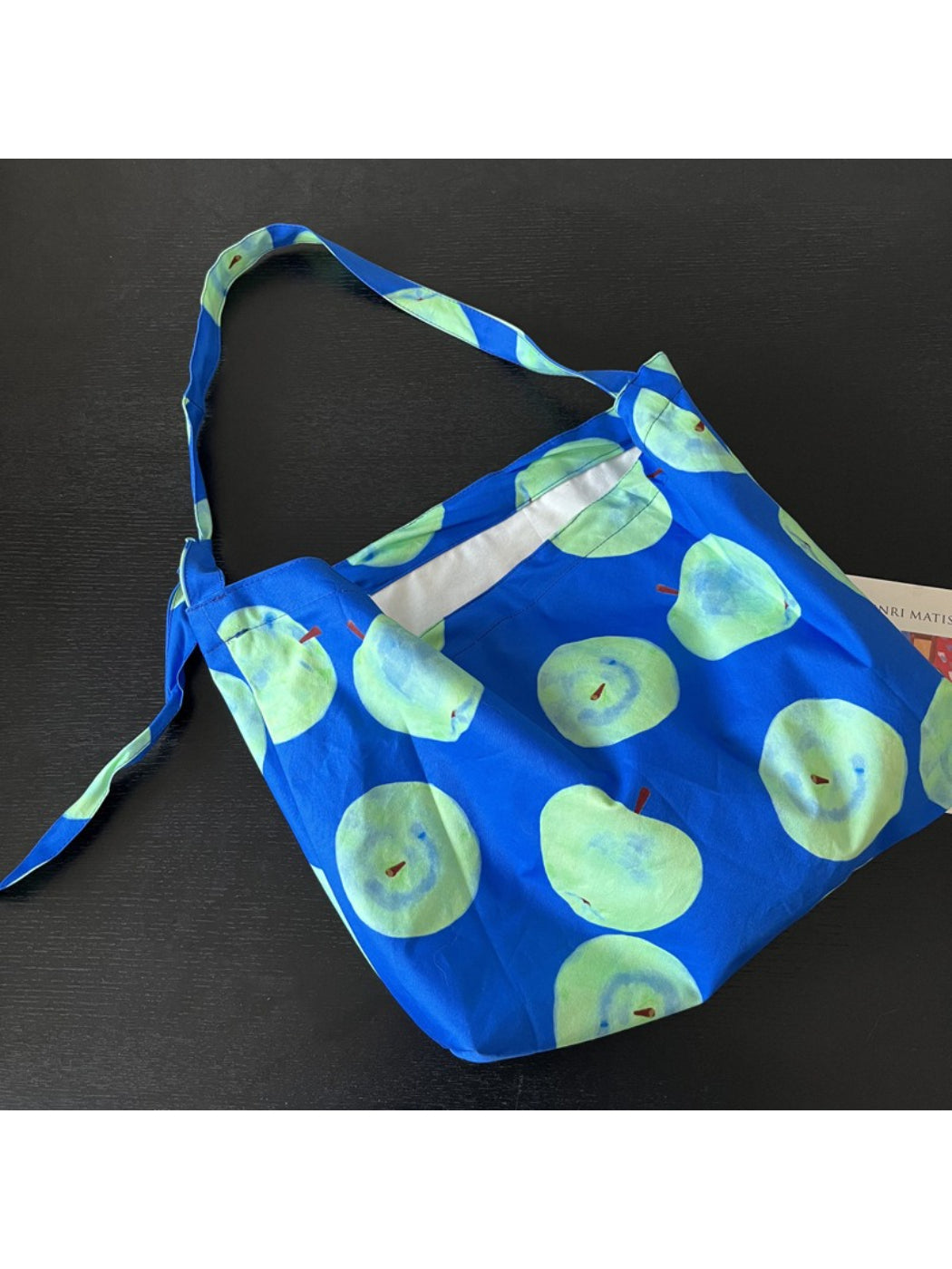 Side view of Cosbai Smiley Apple Shoulder Tote Bag showing shoulder strap