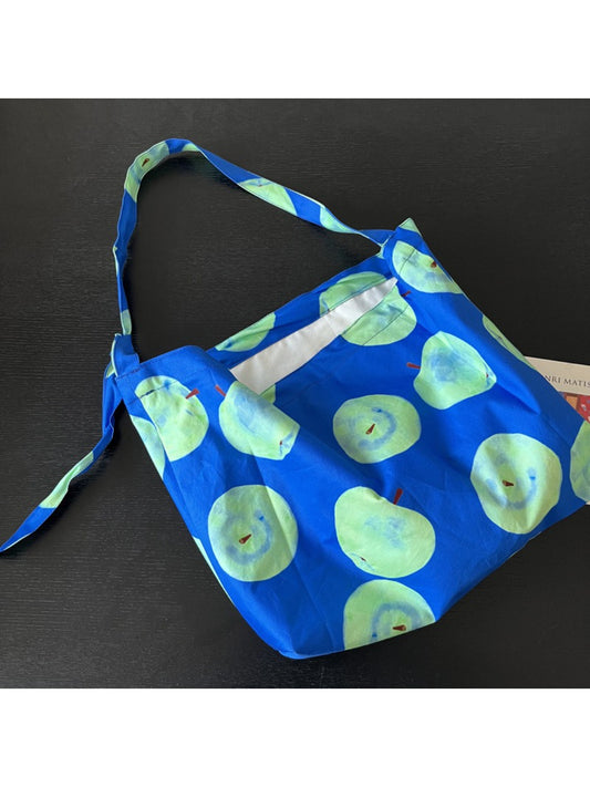 Side view of Cosbai Smiley Apple Shoulder Tote Bag showing shoulder strap