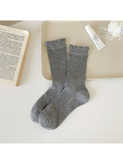 Close-up of fabric texture on Rufia Everyday Ruffle Cuff Crew Socks in cream color