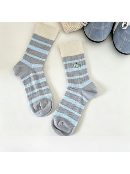 Close-up of Rufia mid-calf socks showing detailed embroidered lace mesh pattern