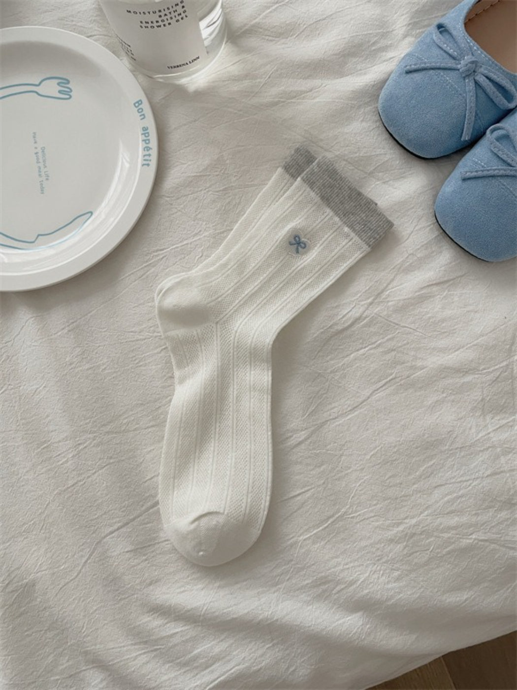 Close-up of floral knit pattern on Rufia lightweight crew socks in soft hues