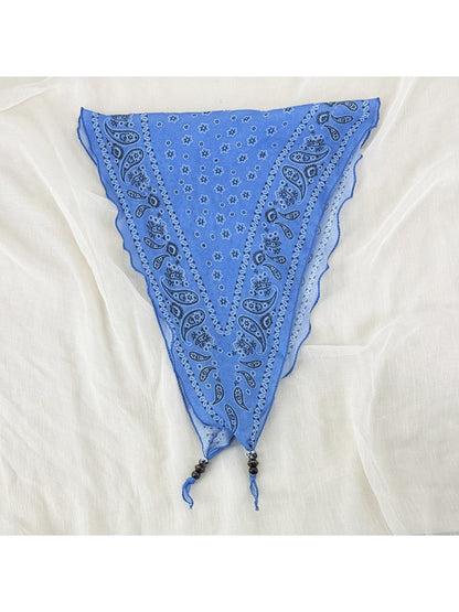 Close-up of fabric pattern on Scarvii vintage bandana headscarf with bead trim