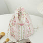 Side view of Cosbai soft floral drawstring handbag highlighting shape and floral print