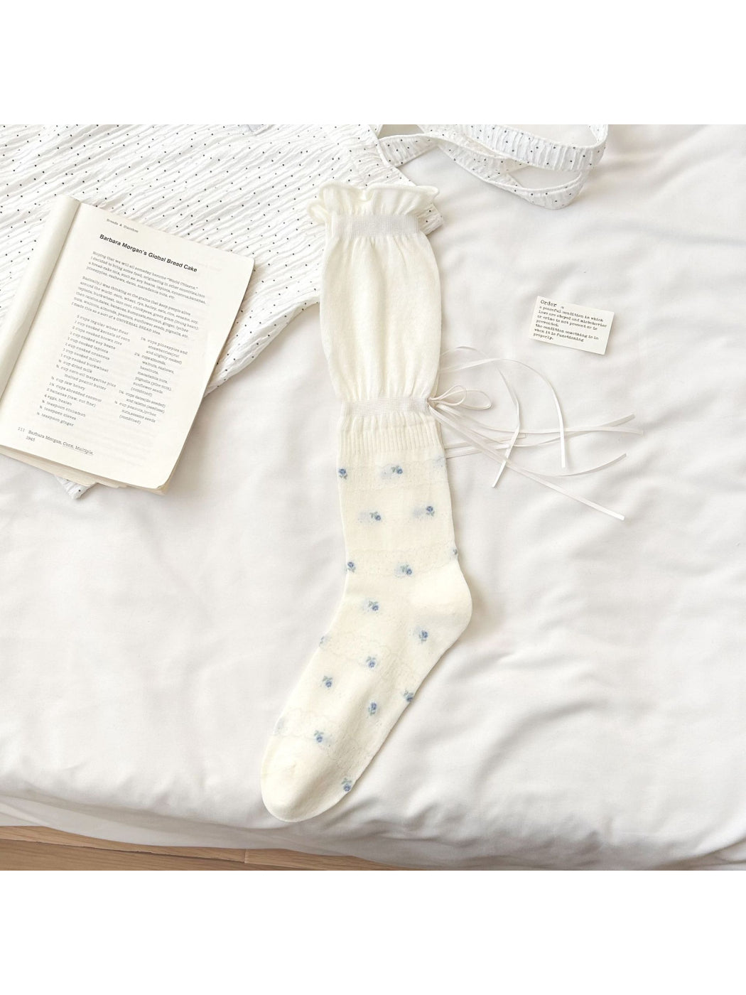 Side view of Rufia Soft Bloom Ruffle Crew Socks showing ribbed texture and floral details