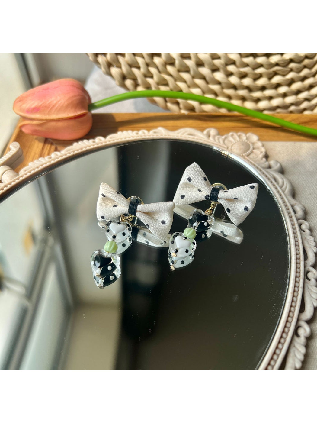 Pair of Earwish Heart Charm Bow Earrings arranged to display both earrings